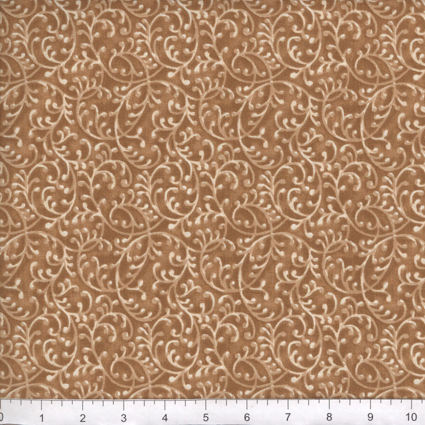 Brown fabric with beige floral pattern, measured against a ruler for scale.