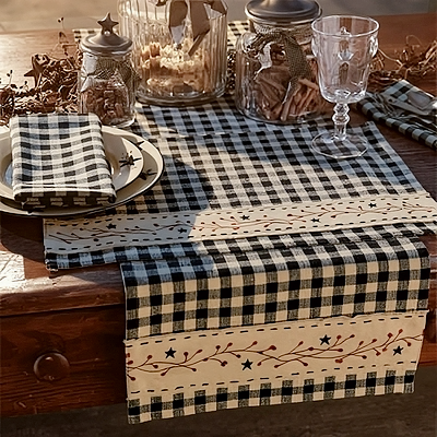 Cozy farmhouse tabletop with black and cream check table runner, placemats, and styled rustic dining setting
