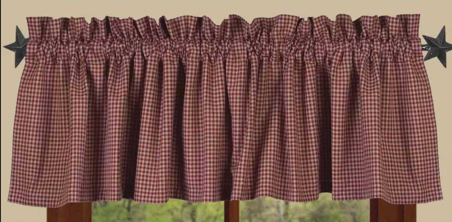 Plaid curtain valance with star decorations on a neutral background