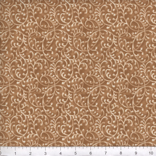 Brown fabric with beige floral pattern, measured against a ruler for scale.