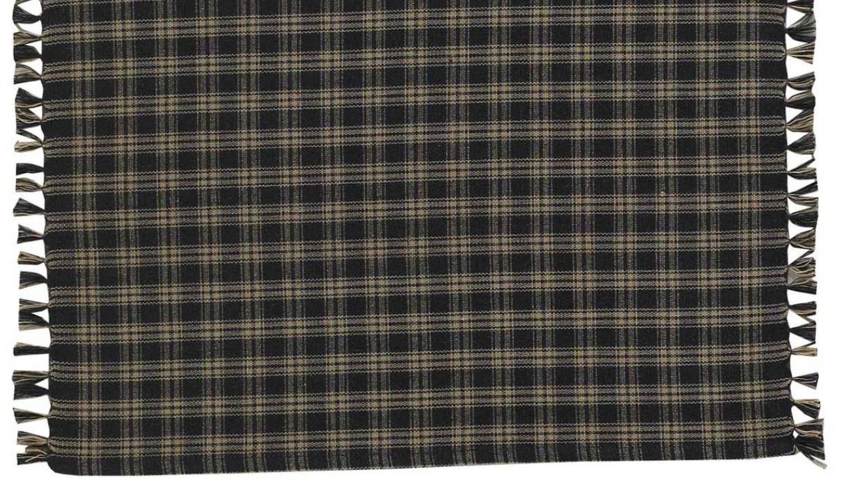 Plaid blanket with tassels on a plain background