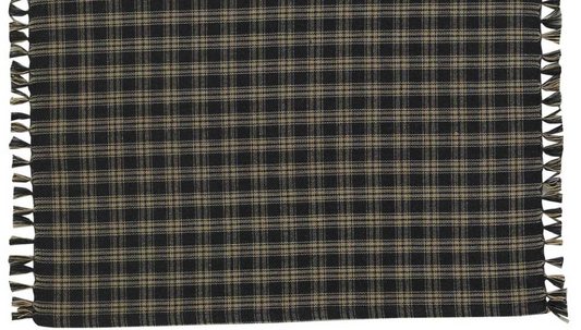Plaid blanket with tassels on a plain background