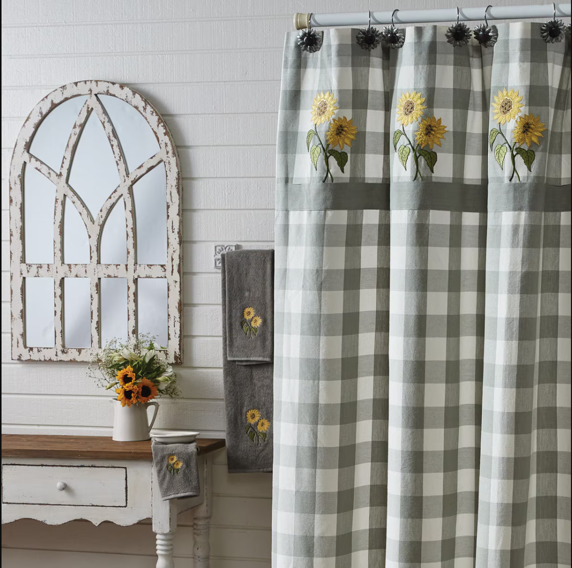 Bathroom with checkered curtain, mirror, and sunflower-themed towels