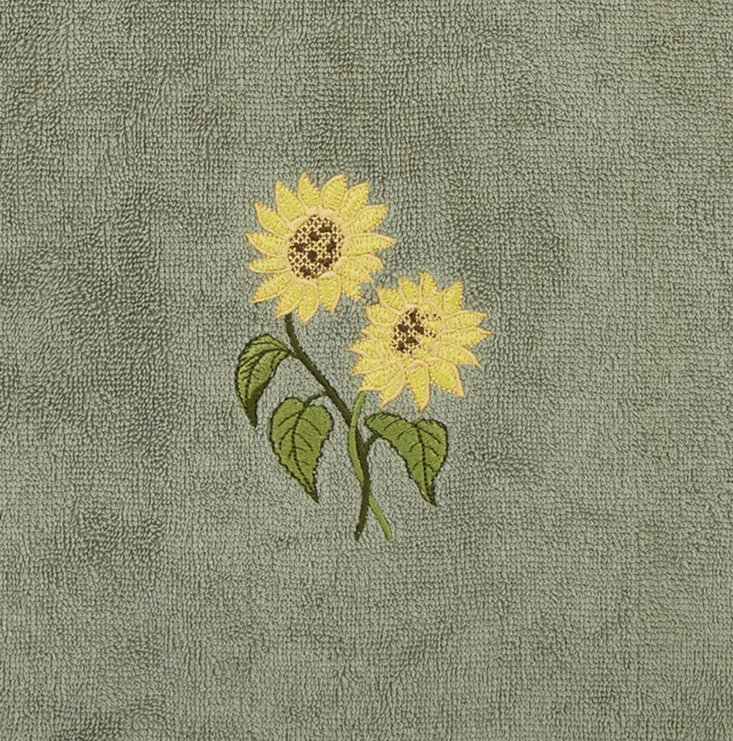 Embroidered sunflowers on a textured green fabric background