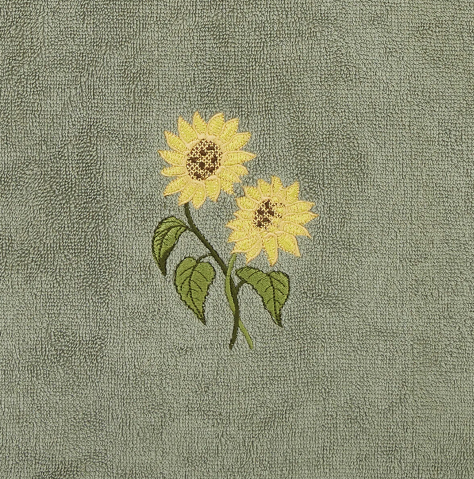 Embroidered sunflowers on a textured green fabric background